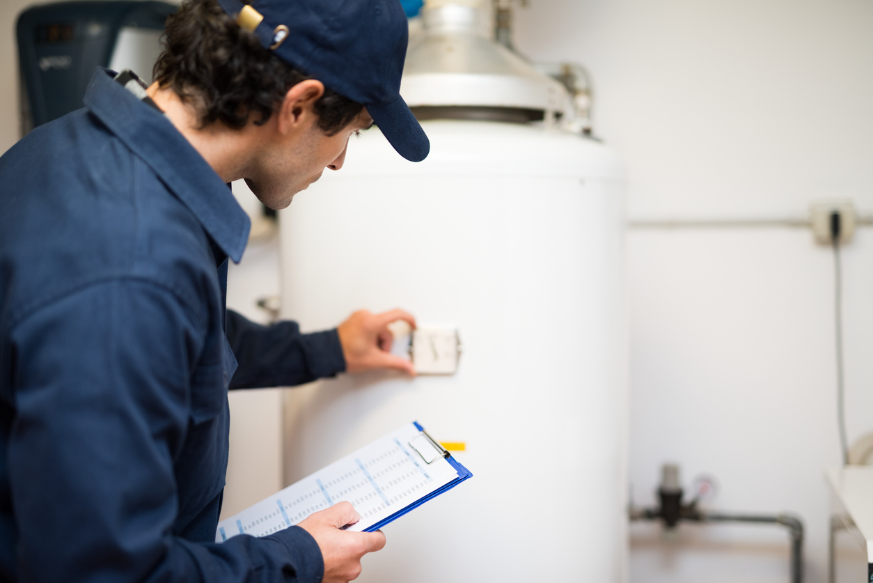 Plumber repairing a hot-water heater