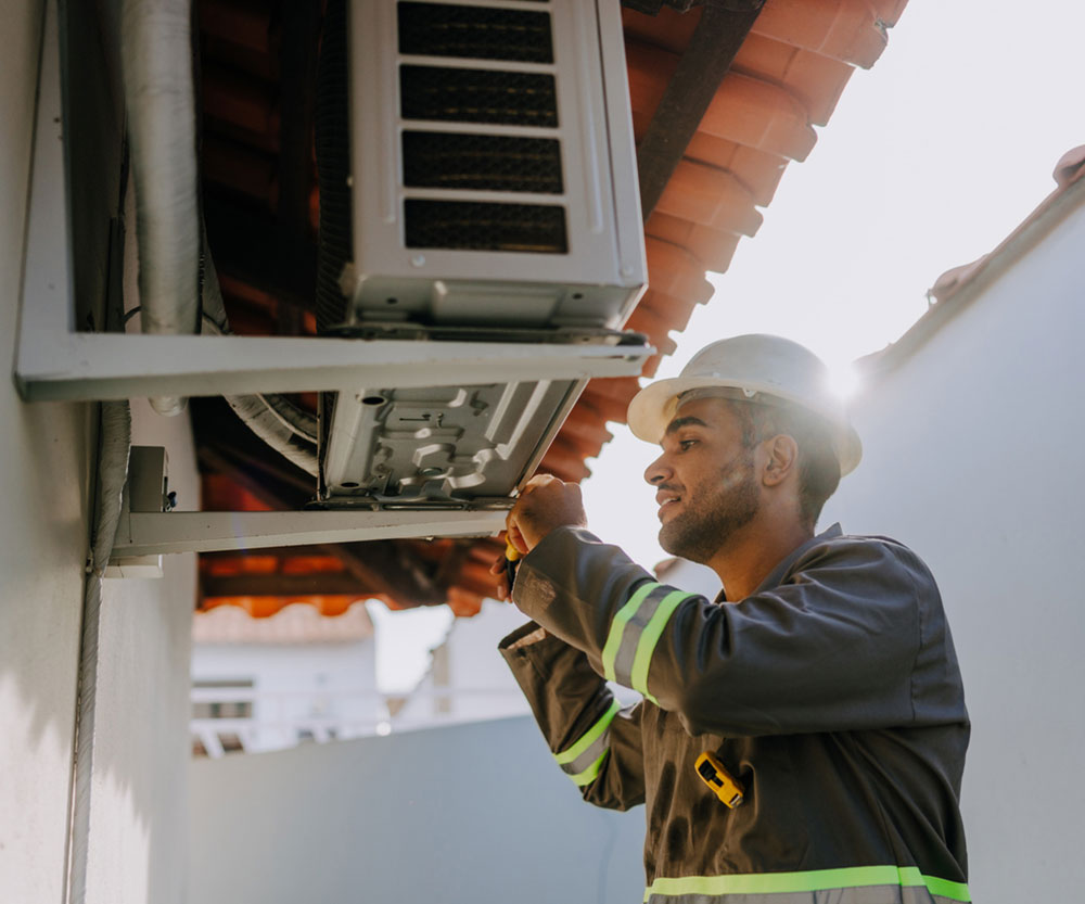 Technician checking air conditioning unit Technician checking air conditioning unit