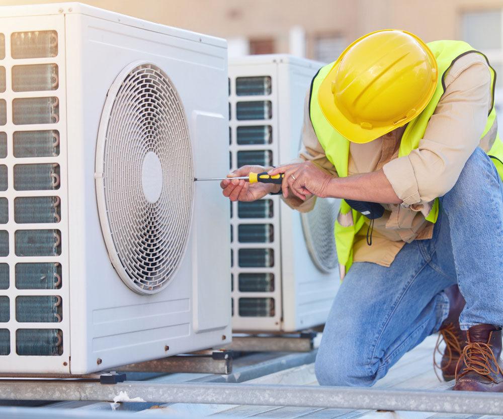 c-1 Technician checking air conditioning unit